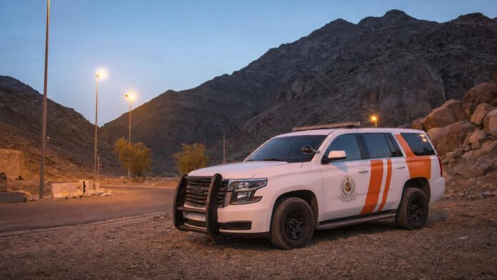 Civil Defense vehicle on a valley road near Makkah at dusk